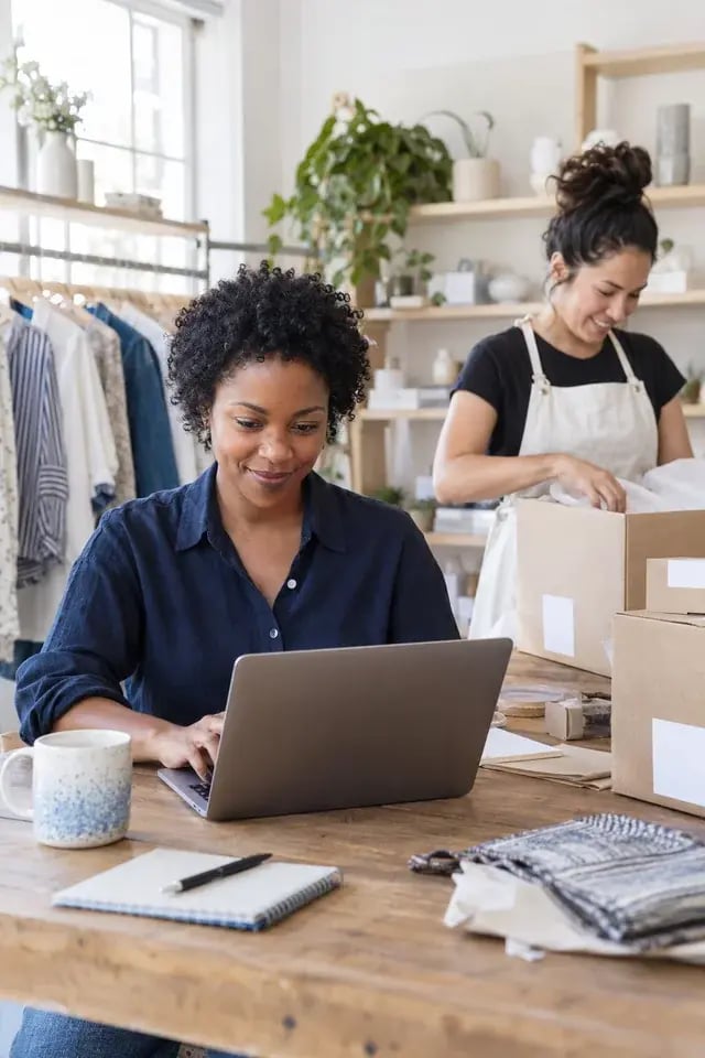 A boutique team managing orders and preparing packages together